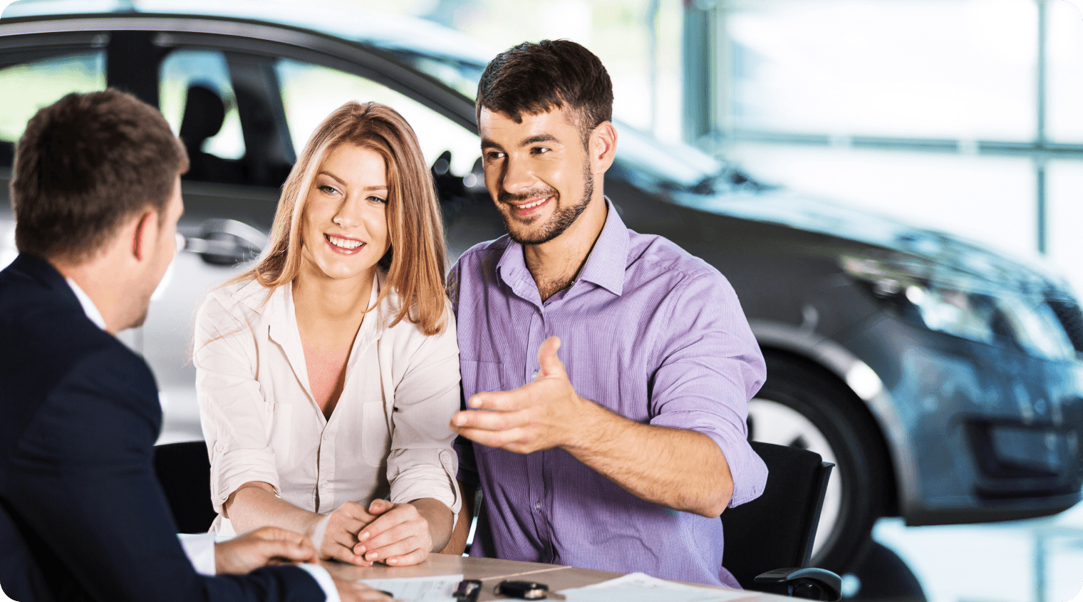 Car dealership team meeting with customers